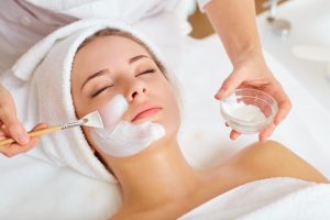 Woman getting a relaxing facial in spa beauty salon